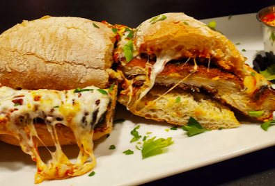 Racca's Pizzeria Napoletana signature dishes T.H.I.S. Sliders
Chicken Parmesan Sandwich
The Butcher Pizza